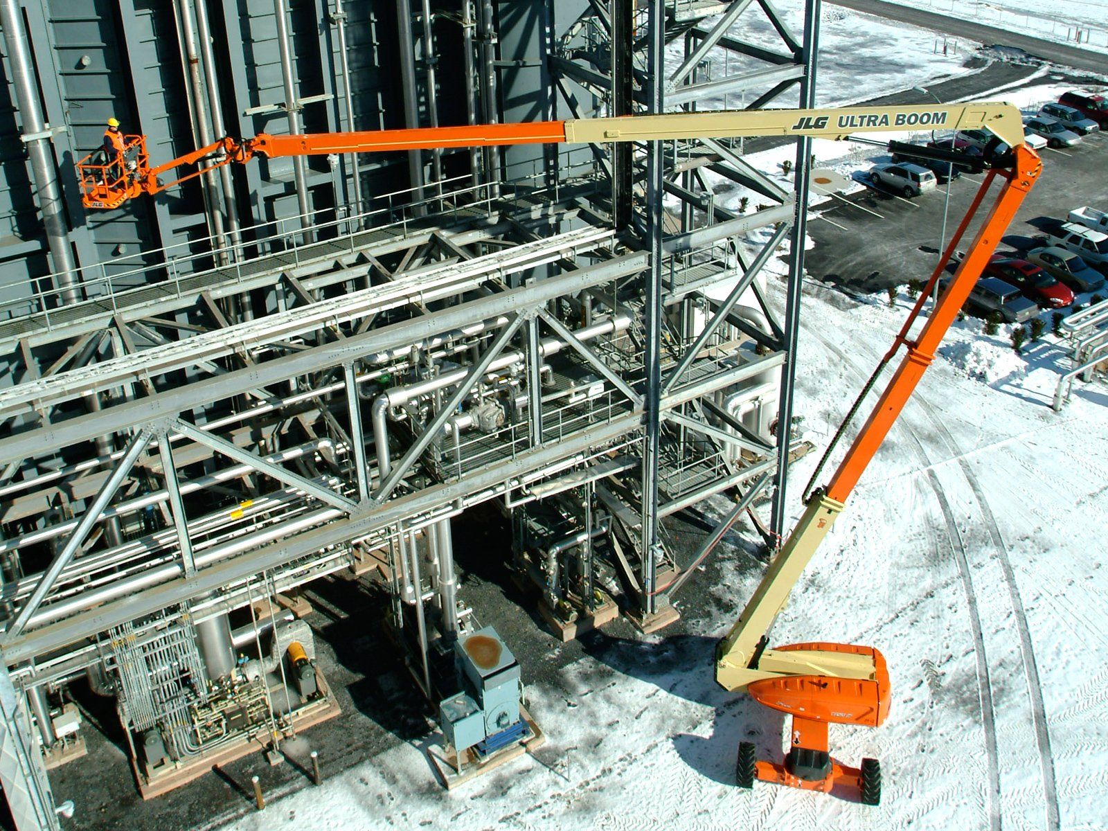 An aerial view of a construction site with a jlg lift in the foreground