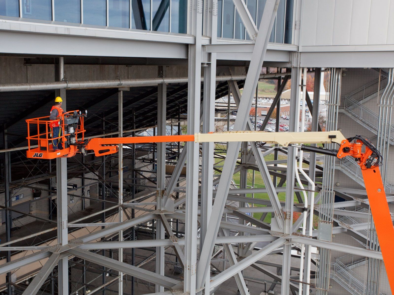 A man is working on a crane on top of a building.
