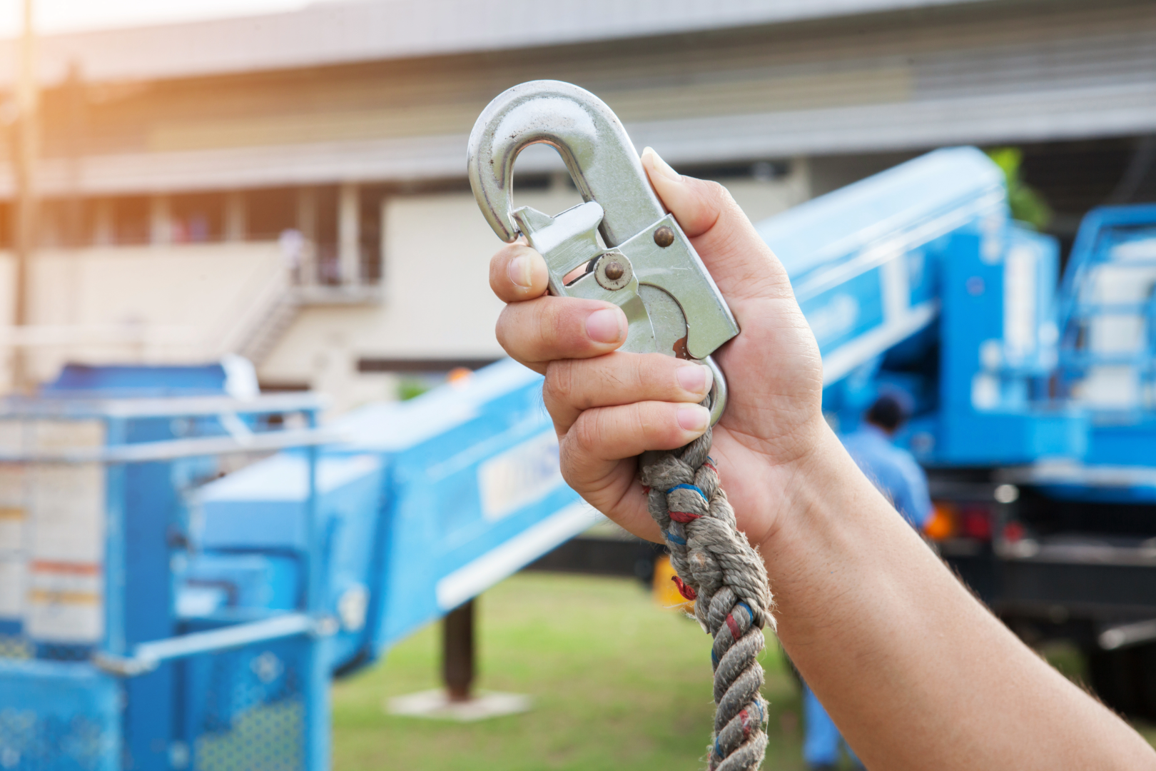 Man operating a spider atrium lift machine, designed for high-access work in tight spaces