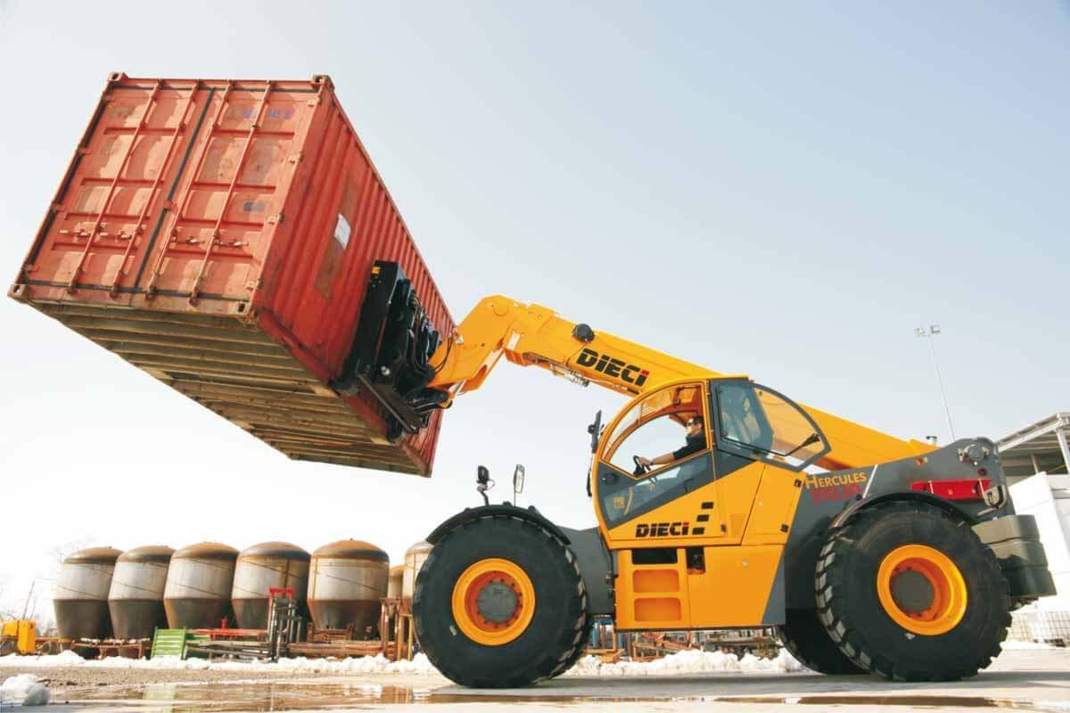 A yellow forklift is lifting a large red container