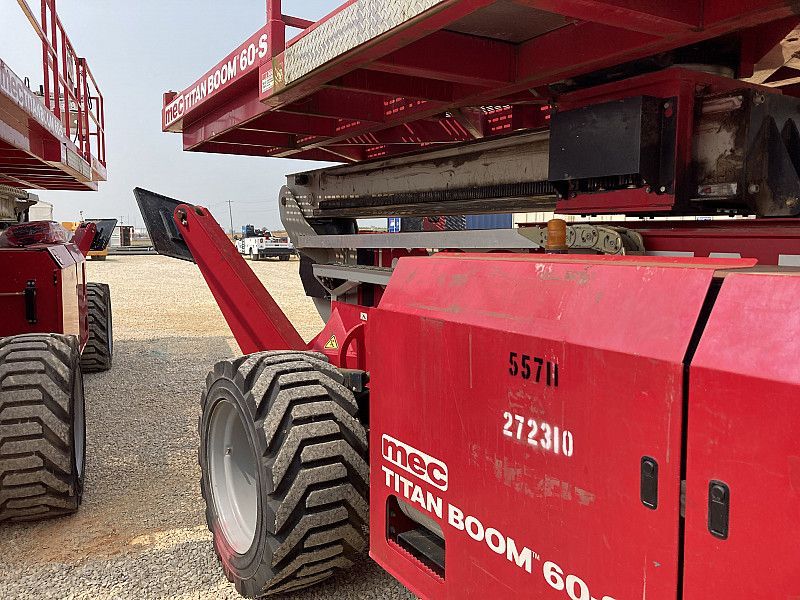 Red MEC Titan 60-S aerial specialty boom with 60 ft height, large platform, and rough terrain tires
