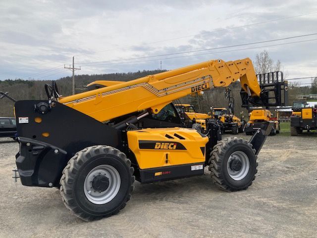 A yellow and black forklift is parked in a dirt lot.