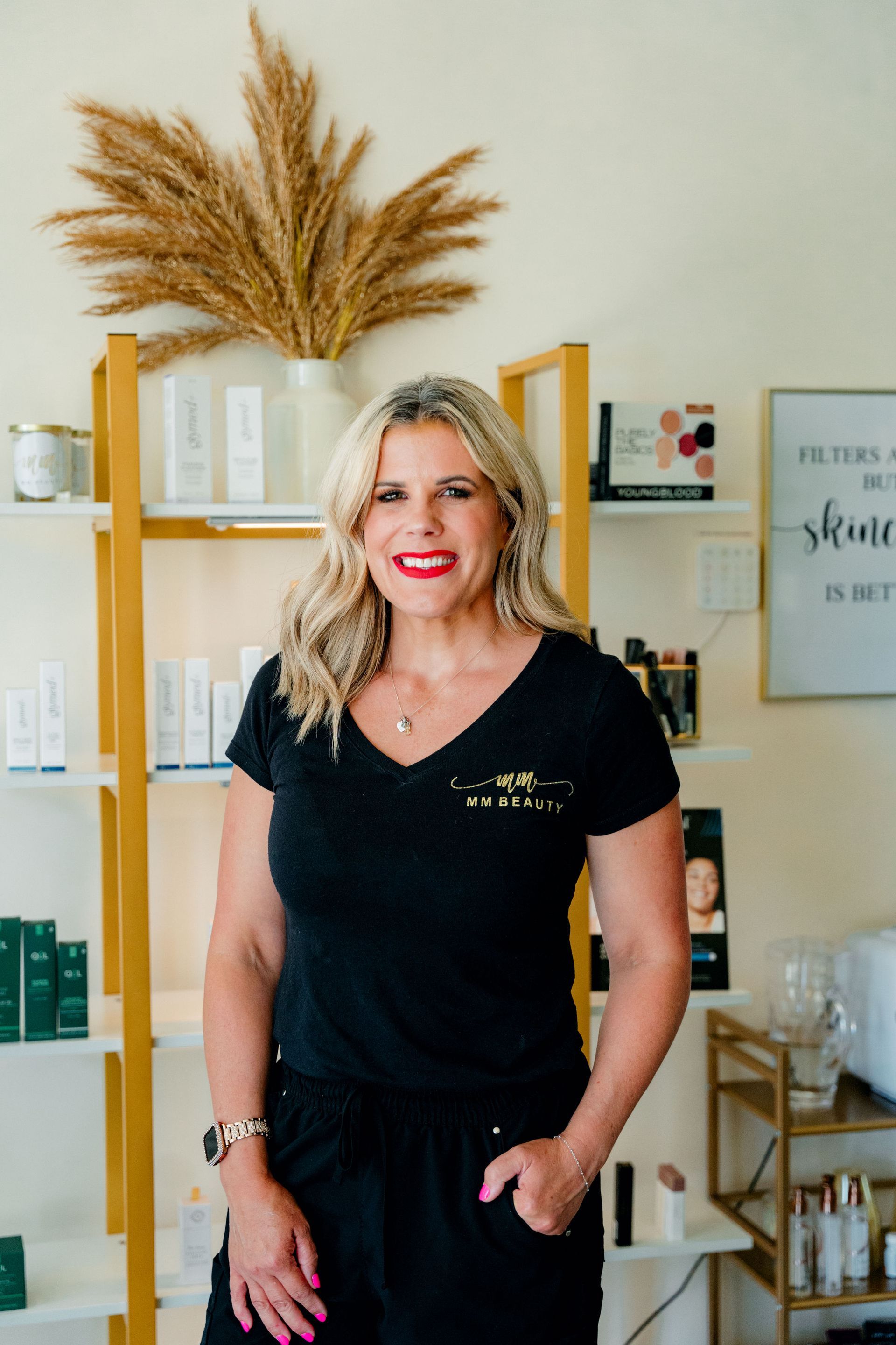 A woman wearing a black shirt with the word beauty on it