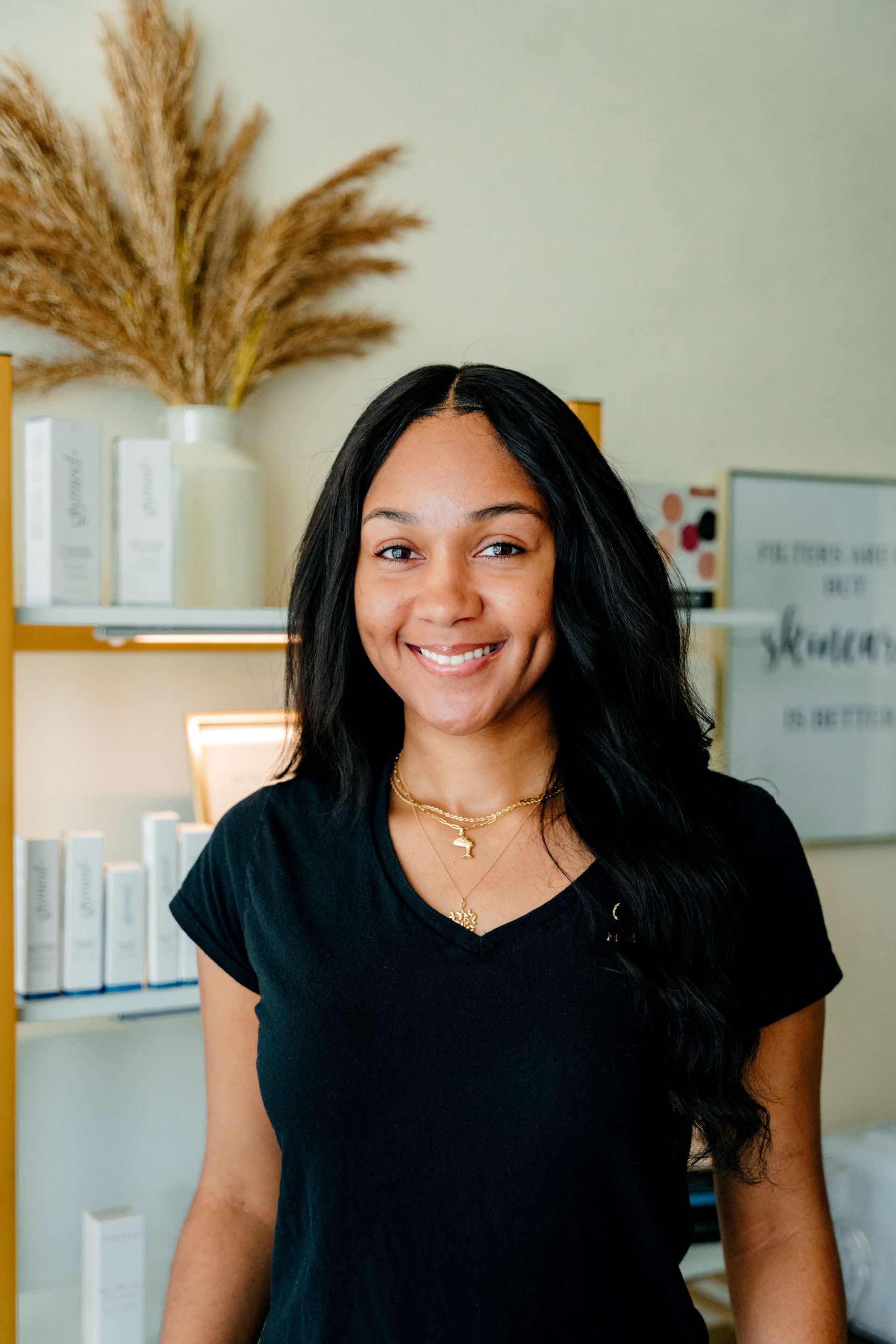 A woman is standing in front of a sign that says mm beauty skin and make studio.