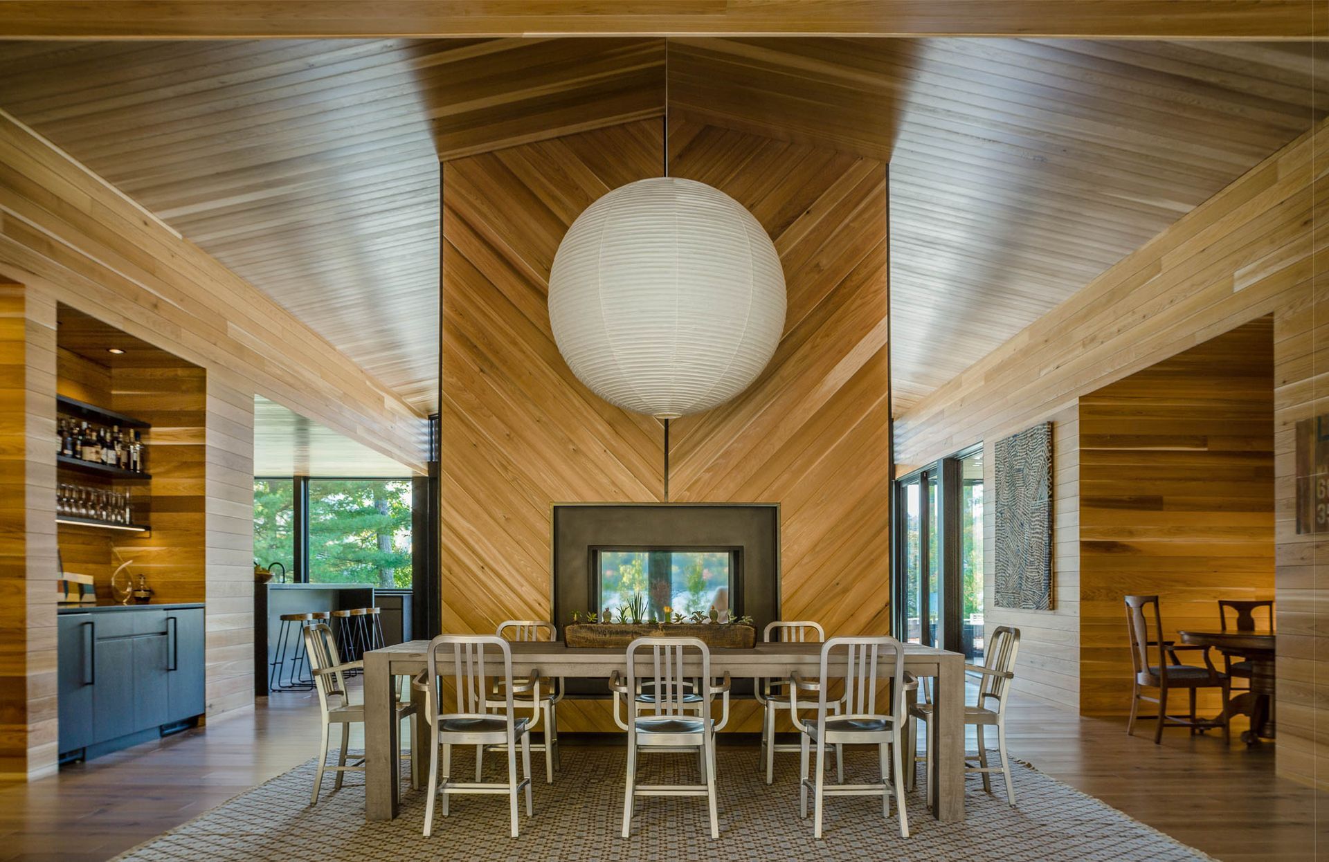 A dining room with a table and chairs and a fireplace