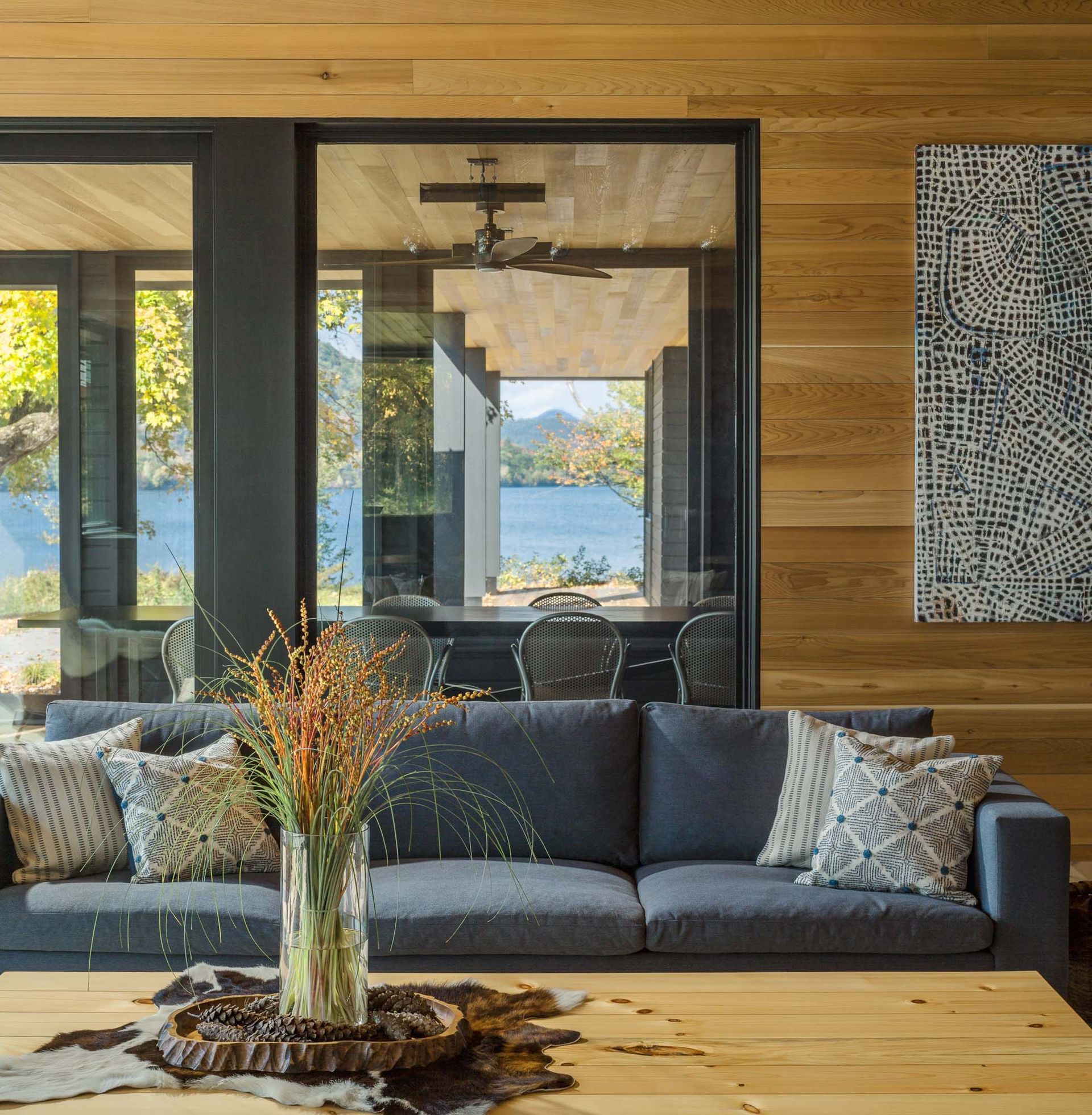A living room with a couch and a table with a vase of flowers on it