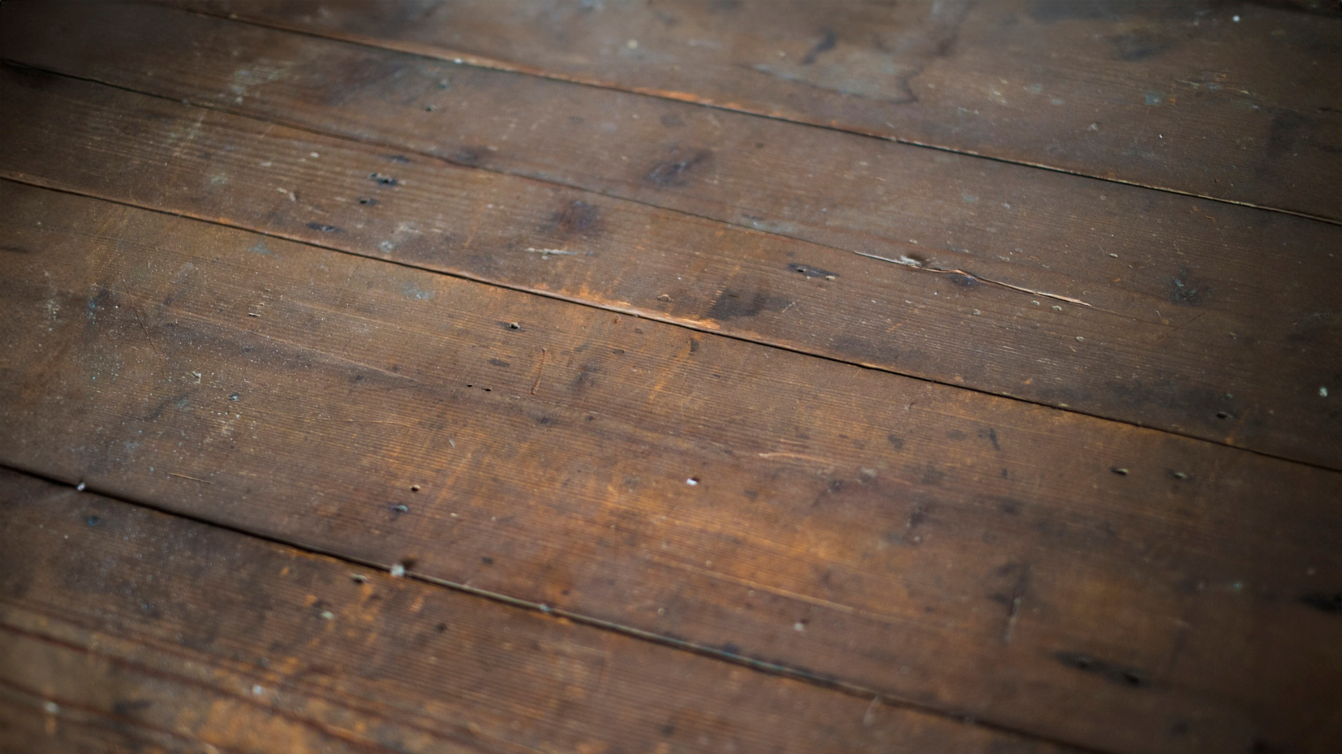 A close-up, angled view of light-toned wood laminate flooring with a distinct, repeating plank pattern.