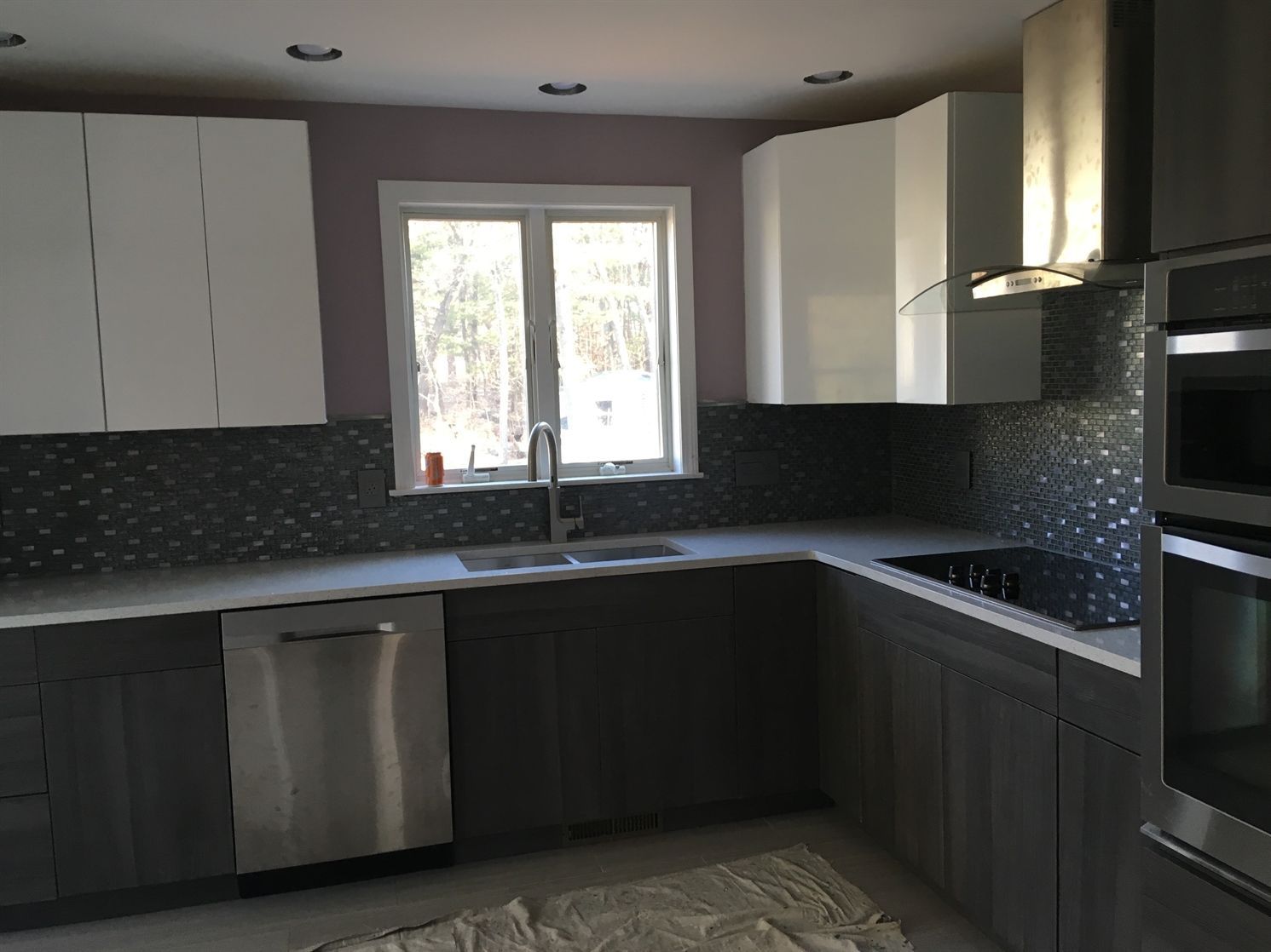 A kitchen with stainless steel appliances and a window