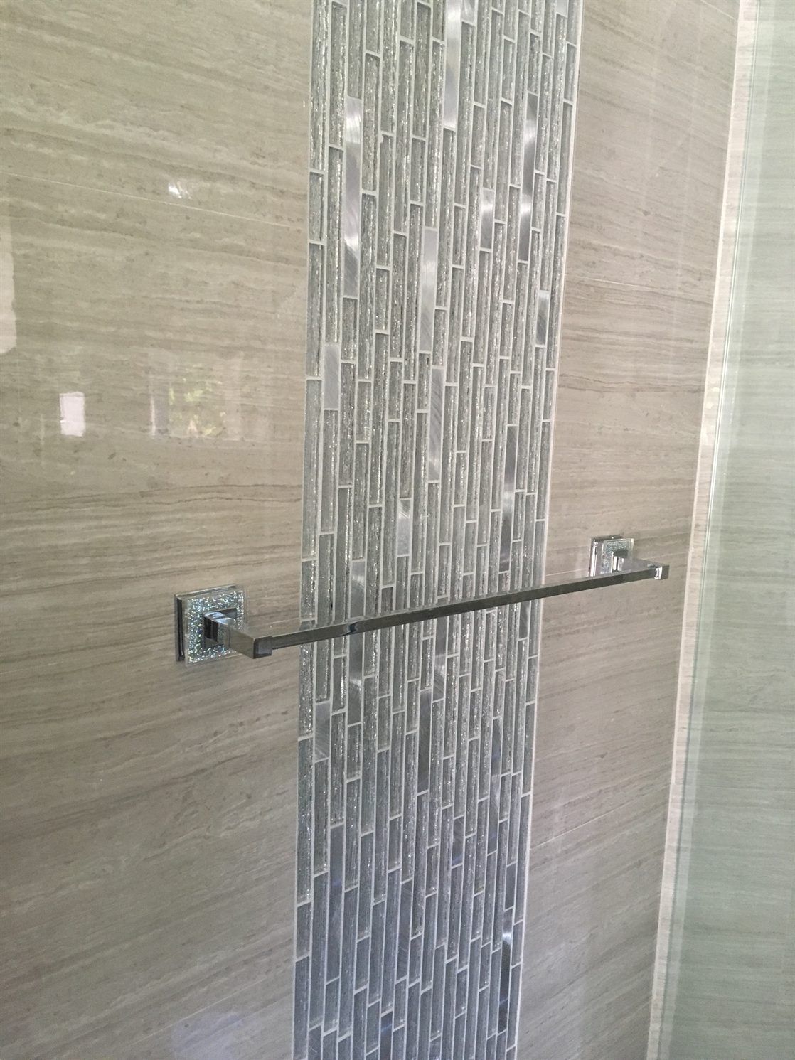 A towel rack is hanging on a wall in a bathroom.