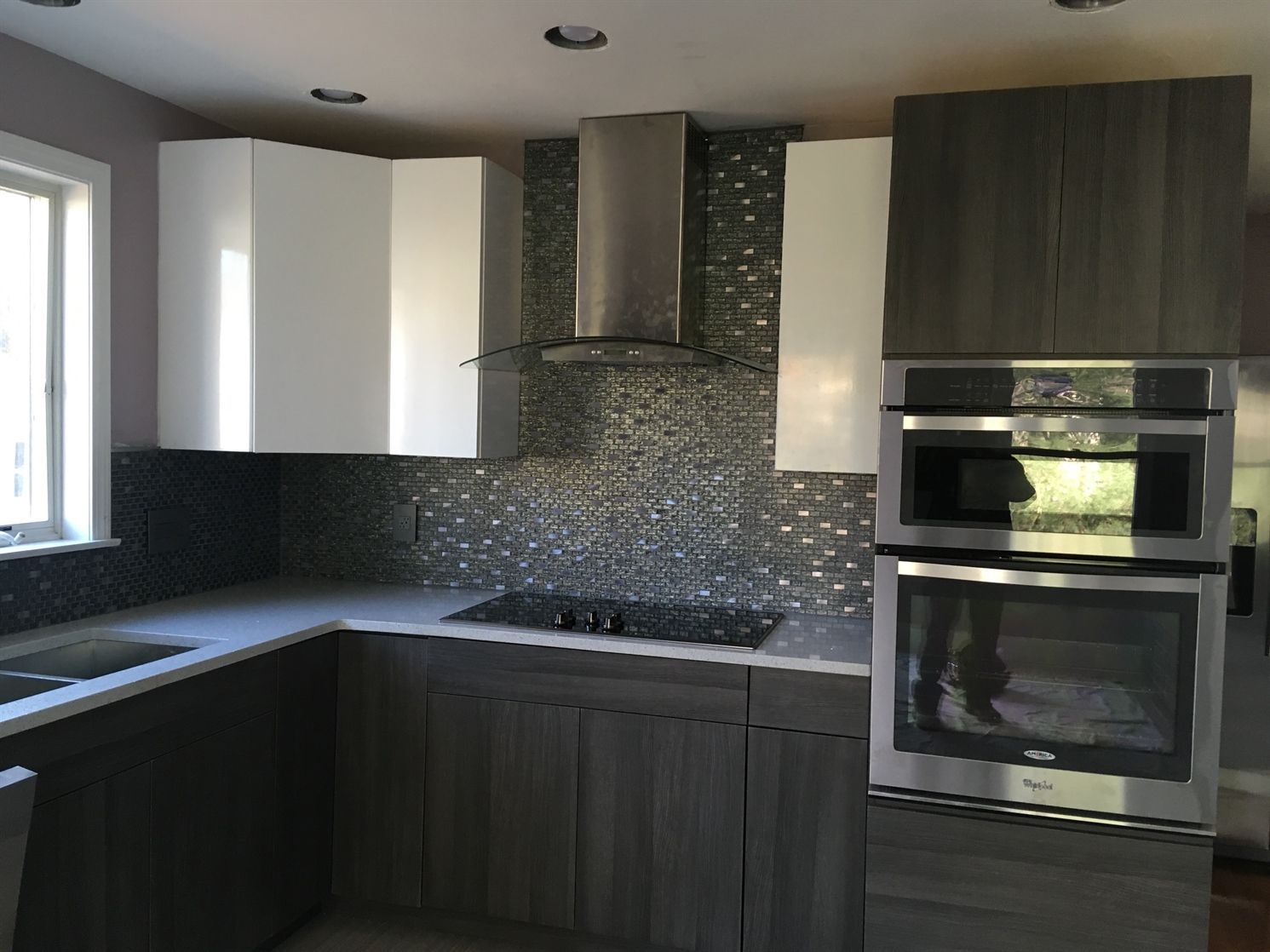 A kitchen with stainless steel appliances and white cabinets