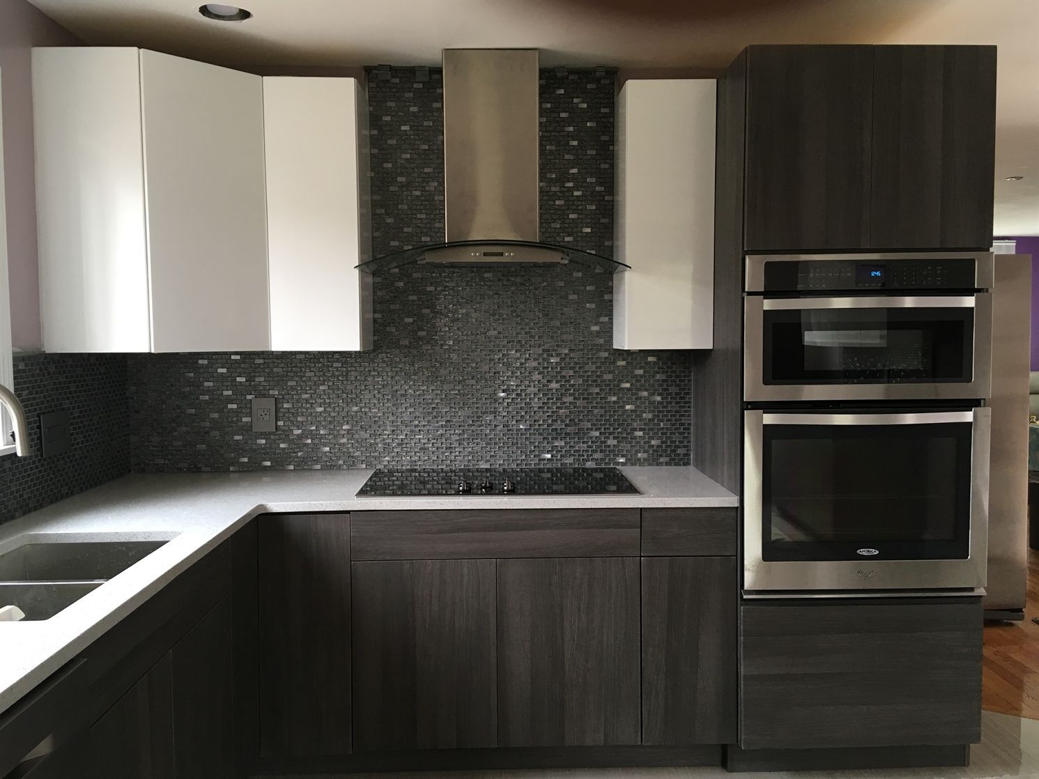 A kitchen with stainless steel appliances and a stove top oven