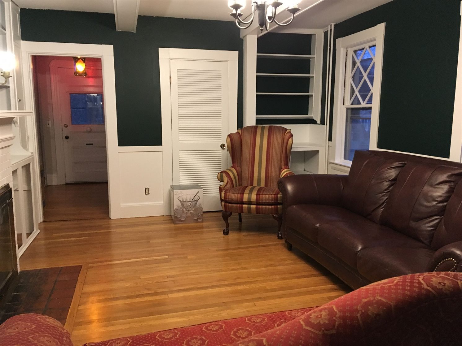 A living room with a couch , chair and fireplace.