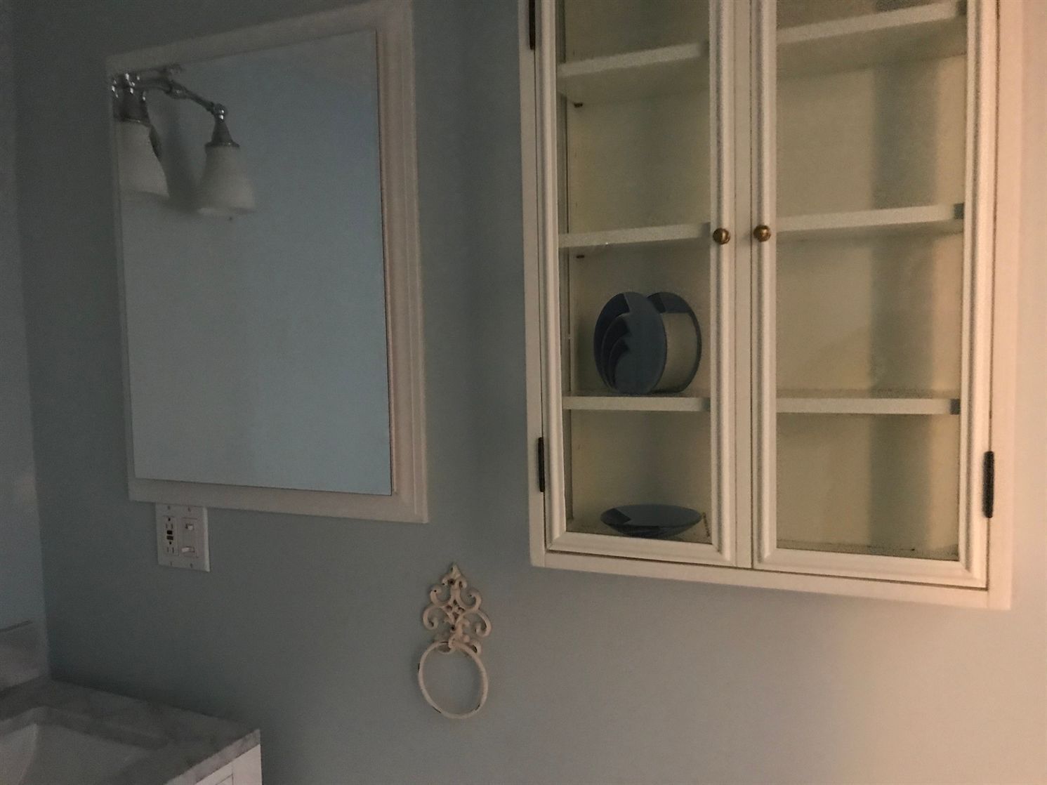 A bathroom with a mirror and a medicine cabinet