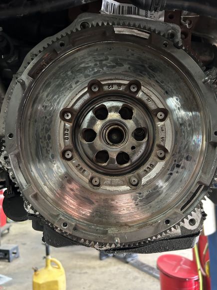 A close up of the underside of a car with a tire and shock absorber.