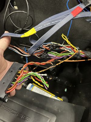 A bunch of wires are connected to a car dashboard