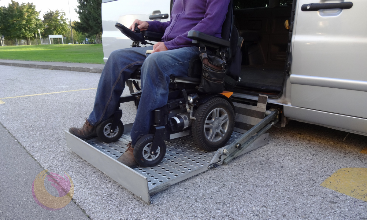 Person living with disability on a wheelchair exiting a van