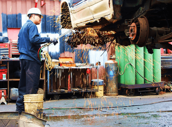 Man Working On Wrecked Car — Kearny, NJ — Bibbs Auto Recycling