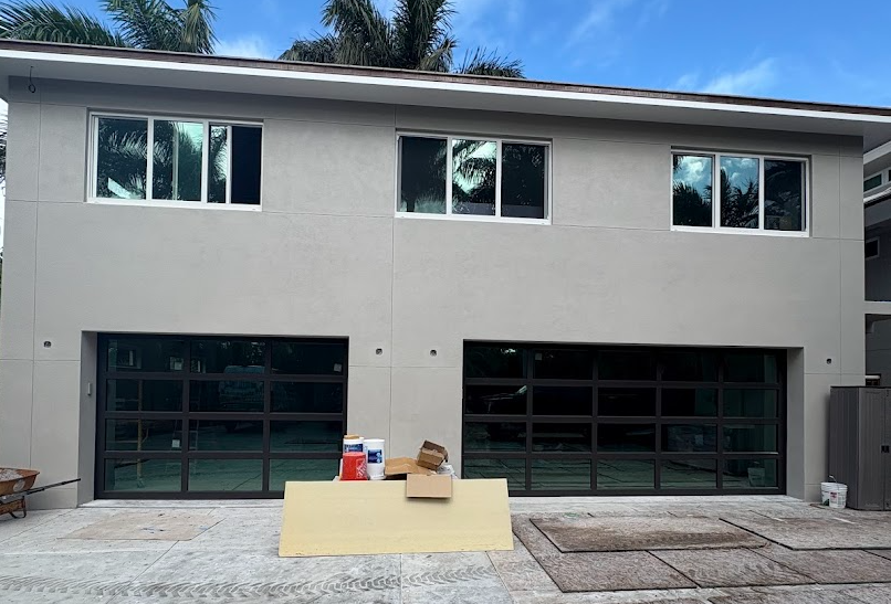 A light blue house with white shutters on the windows