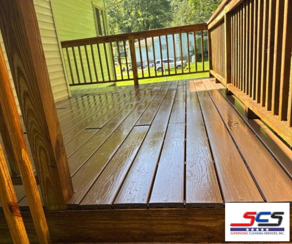 Wooden deck with freshly stained brown boards and railings.