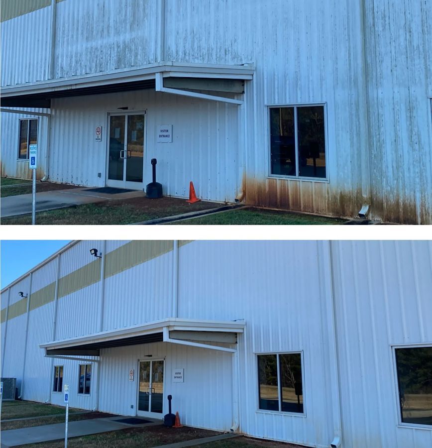 Before and after photos of a white industrial building with a stained exterior being cleaned.