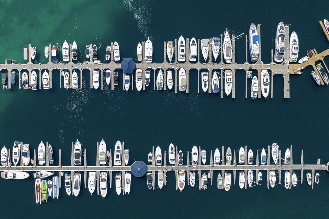 A row of boats are lined up on a dock