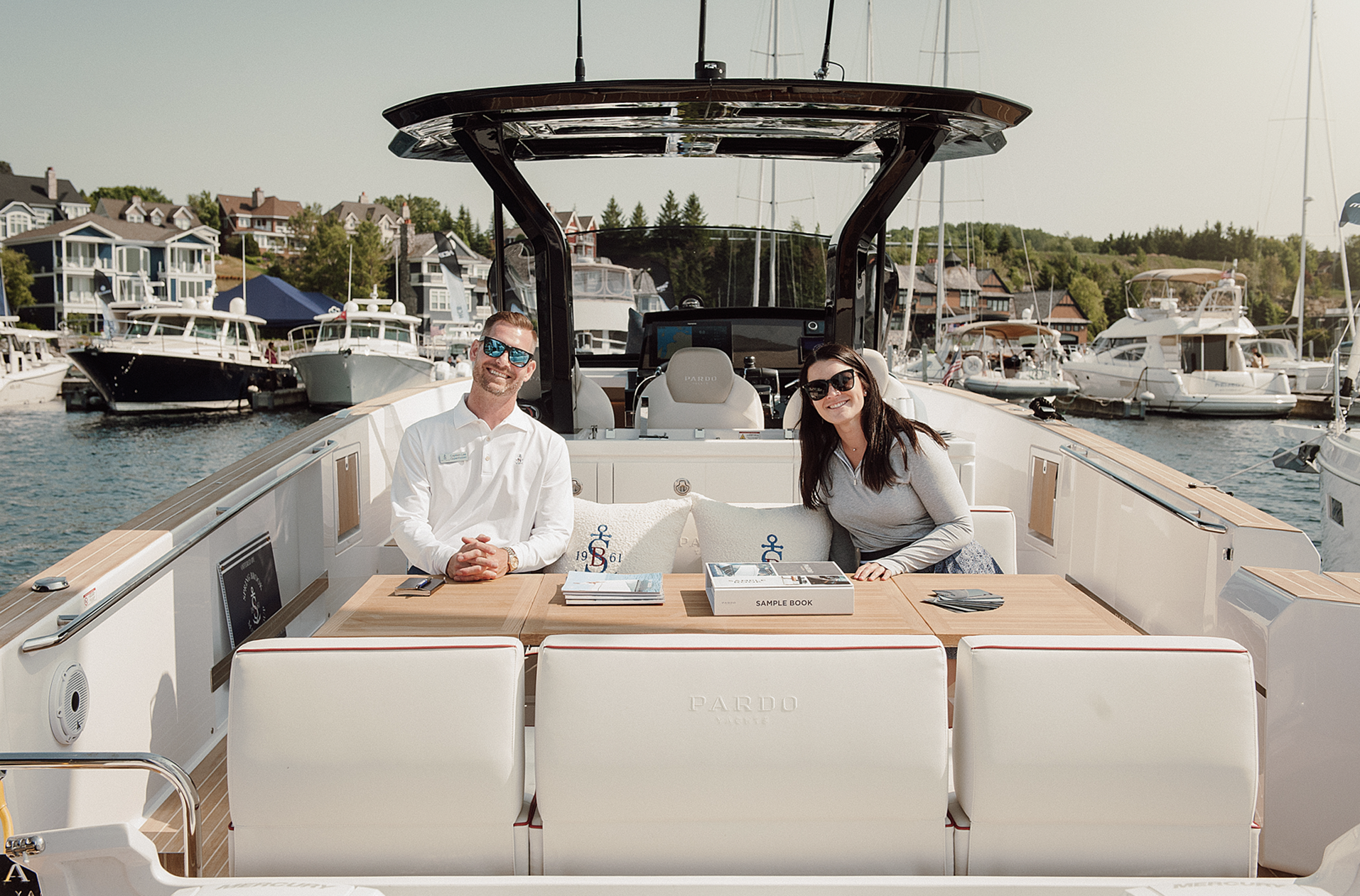 A man and a woman are sitting on the back of a boat.