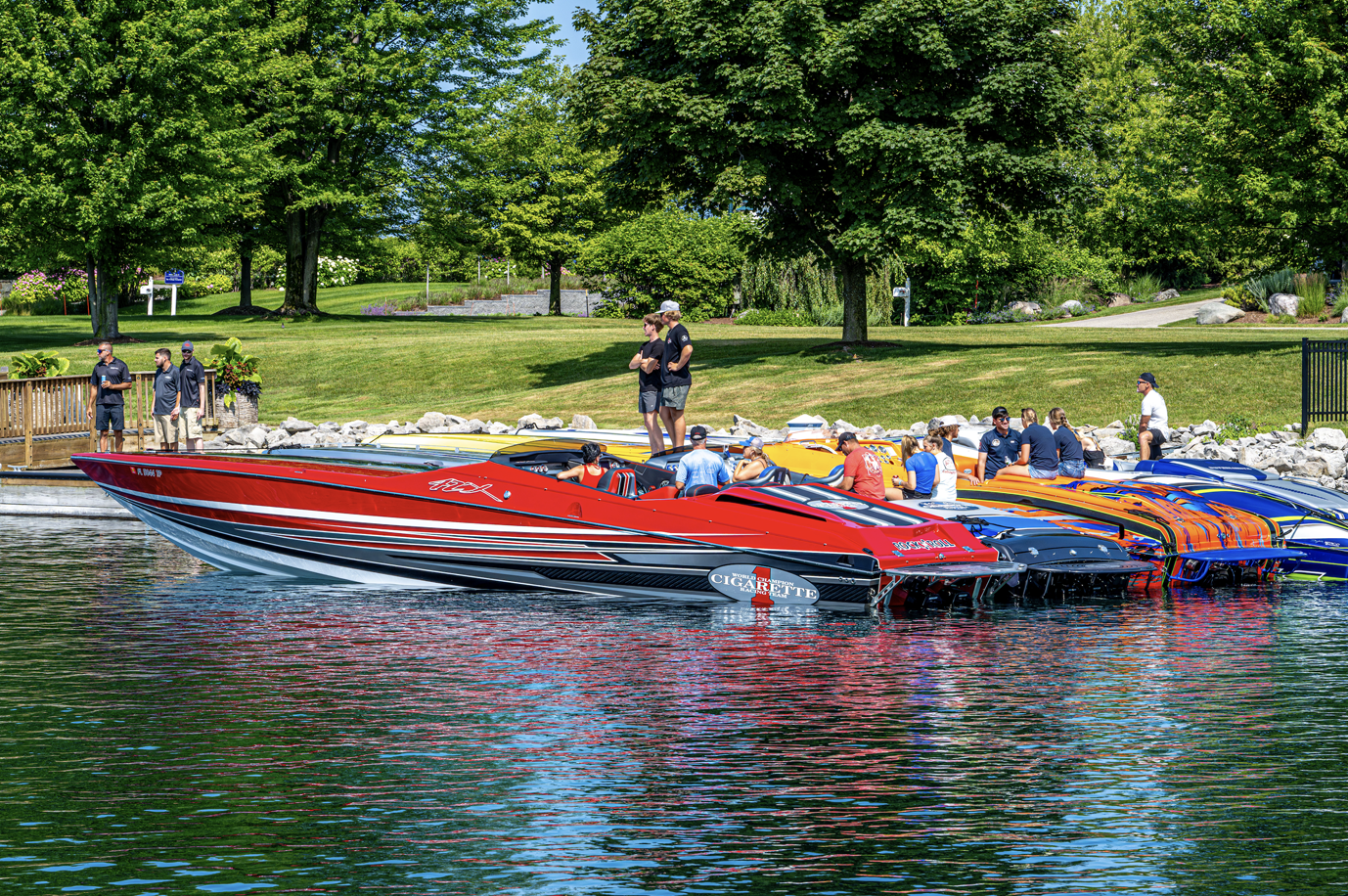 A group of boats are floating on top of a lake.