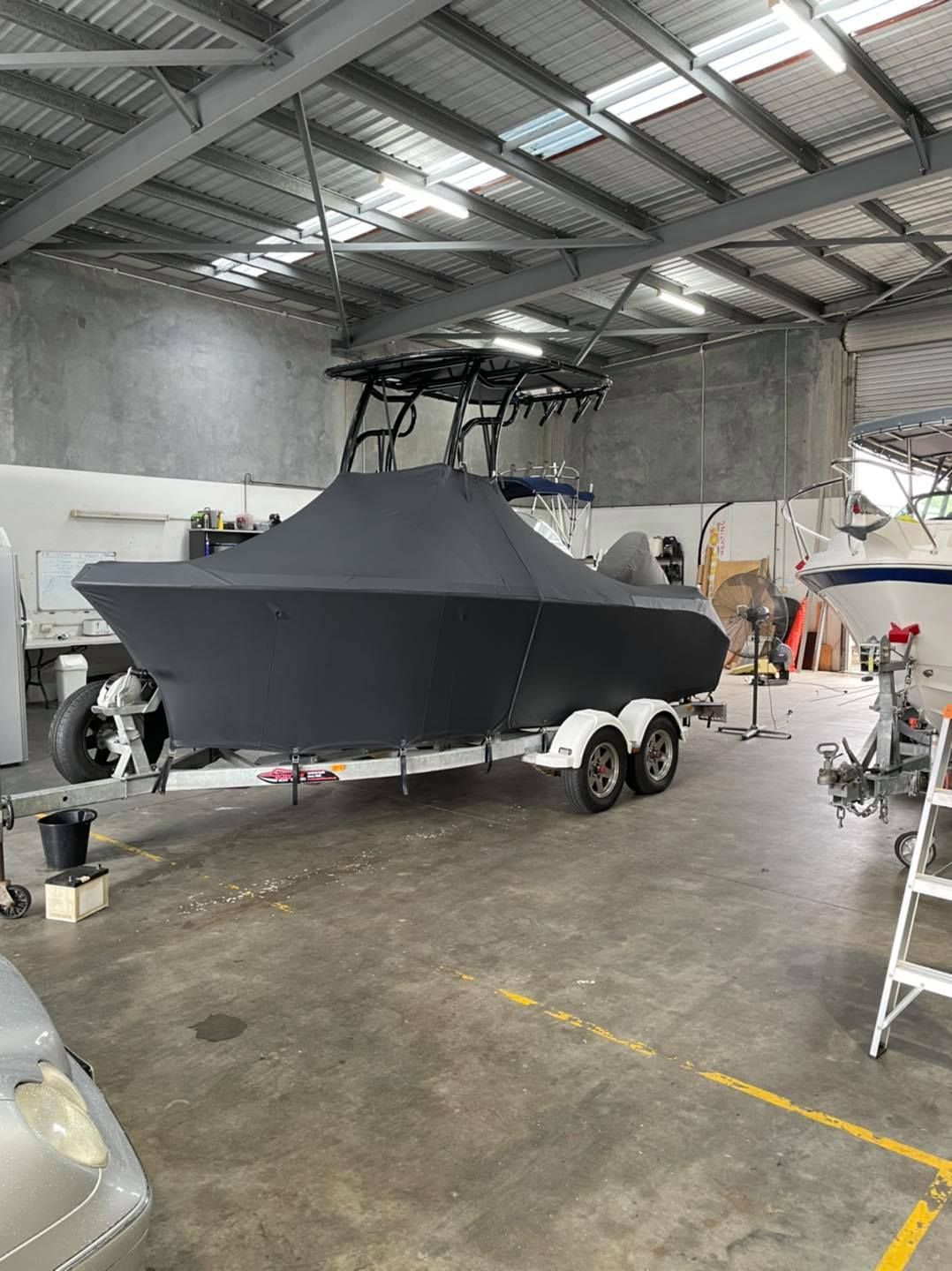 Boat With Cover Inside The Garage — Cairns Vinyl & Canvas in Bungalow, QLD
