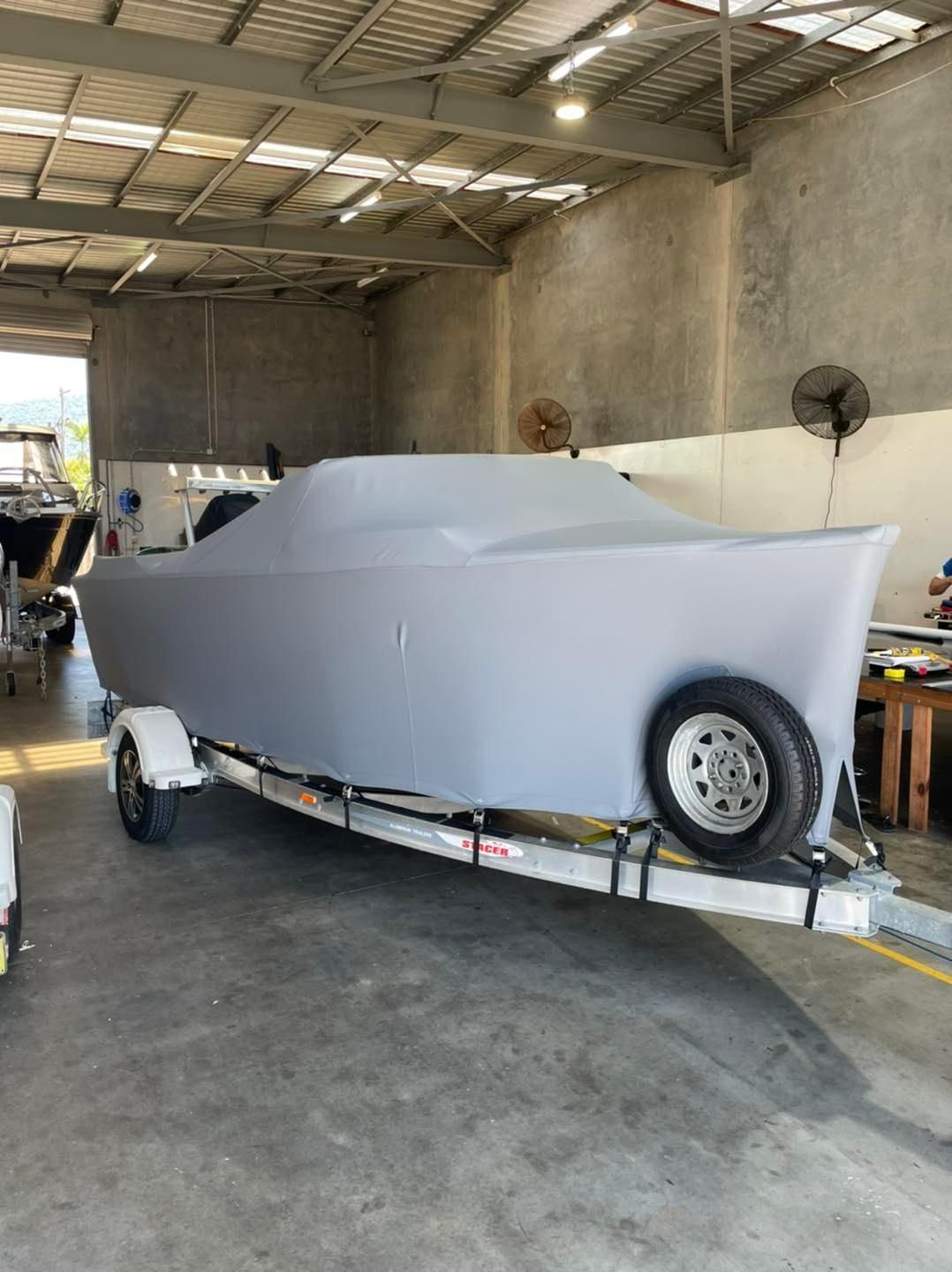 Boat On A Trailer With Cover Inside The Garage — Cairns Vinyl & Canvas in Bungalow, QLD