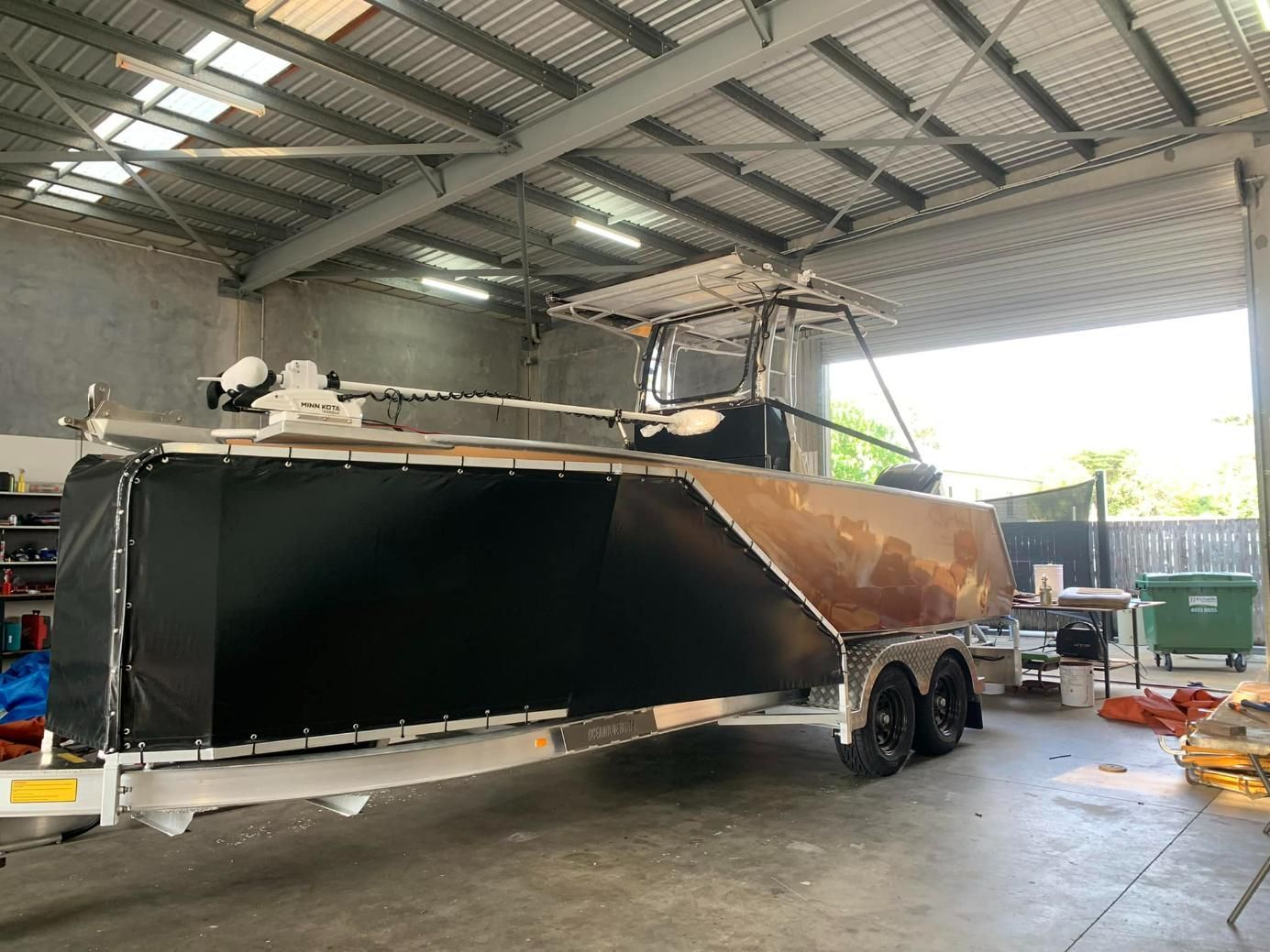 Boat With Stone Guards Inside The Garage — Cairns Vinyl & Canvas in Bungalow, QLD
