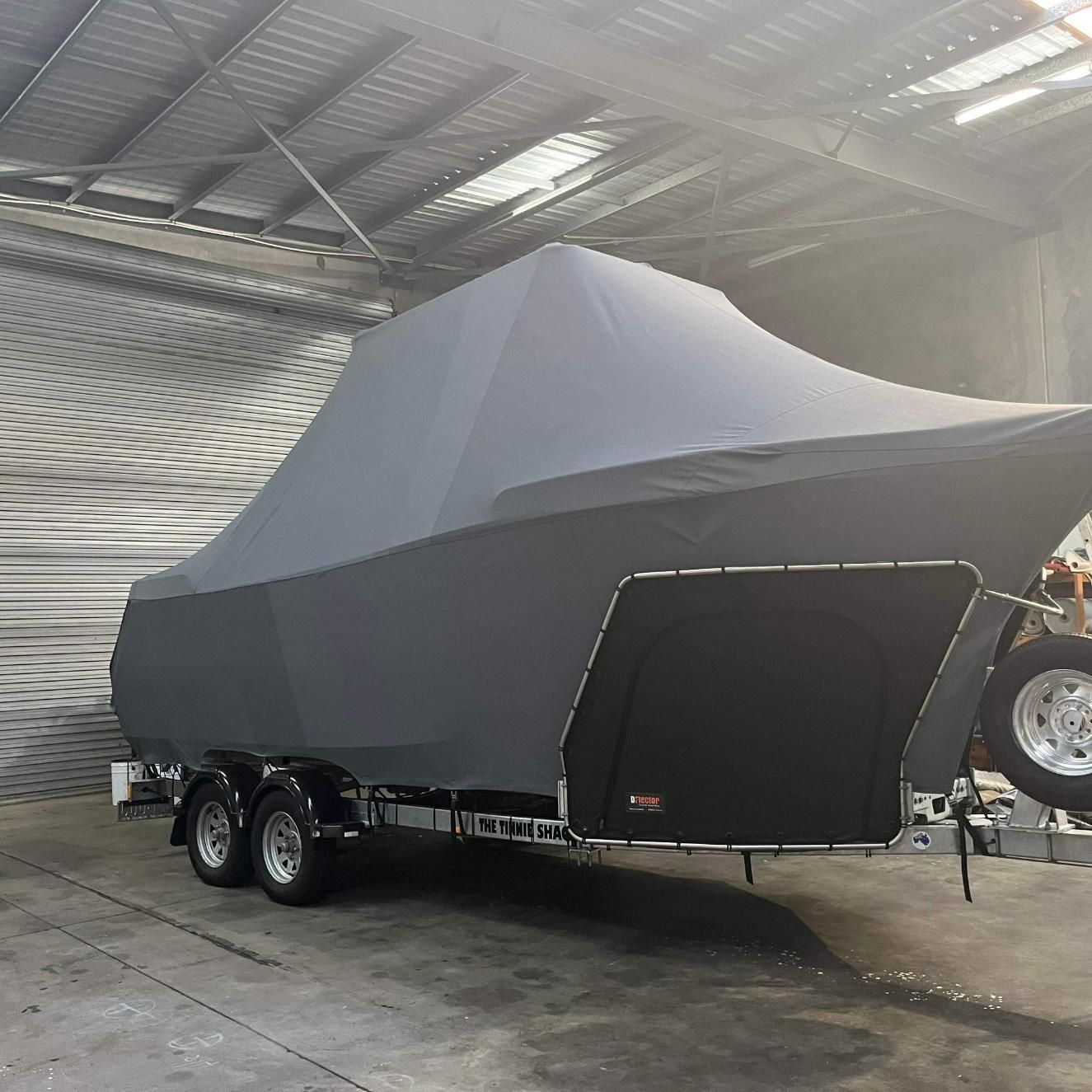 Large Boat With Cover In The Garage — Cairns Vinyl & Canvas in Bungalow, QLD