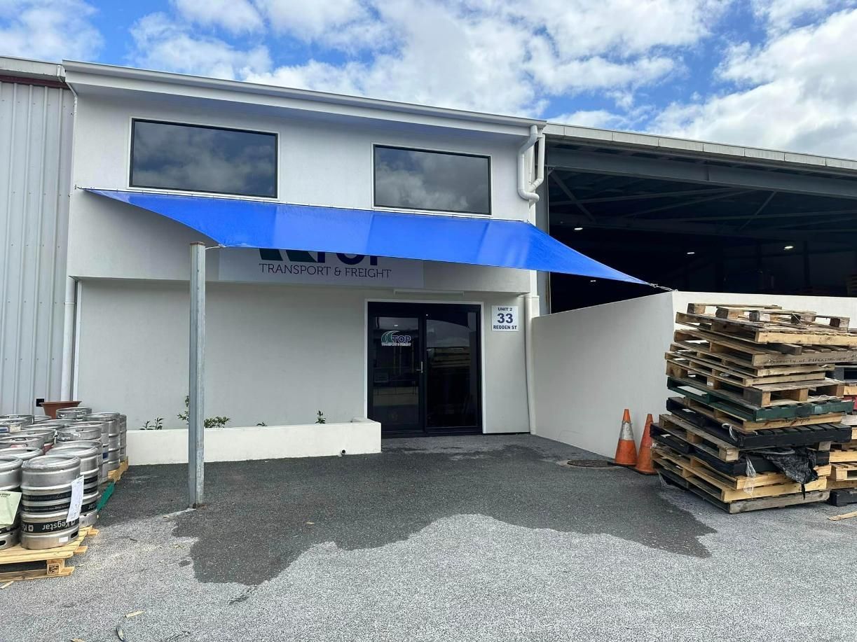 Blue Shade Sails In Front Of A Building — Cairns Vinyl & Canvas in Bungalow, QLD