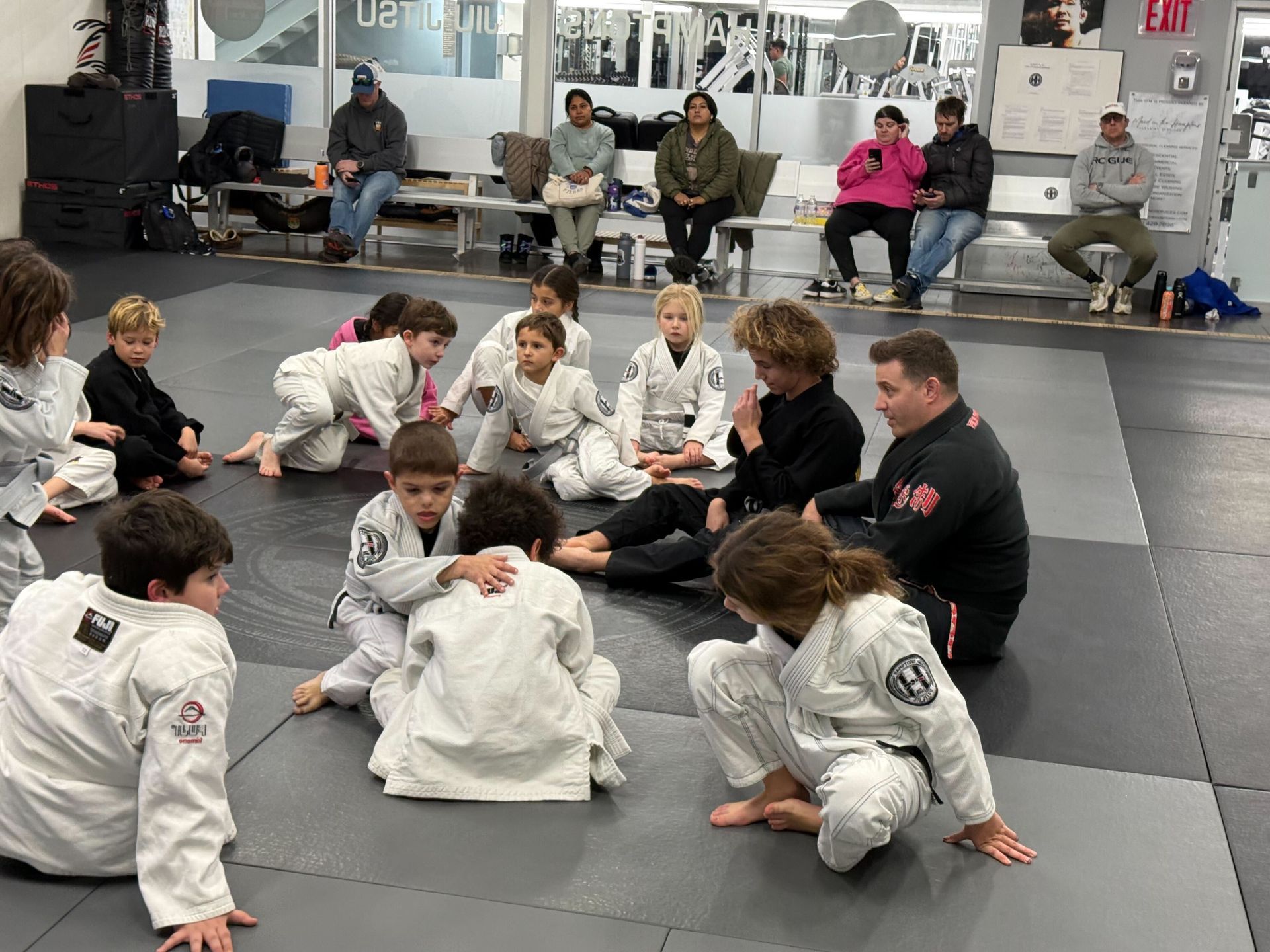 Adults practicing jiu jitsu techniques at Hamptons Jiu-Jitsu in Southampton NY for stress relief.