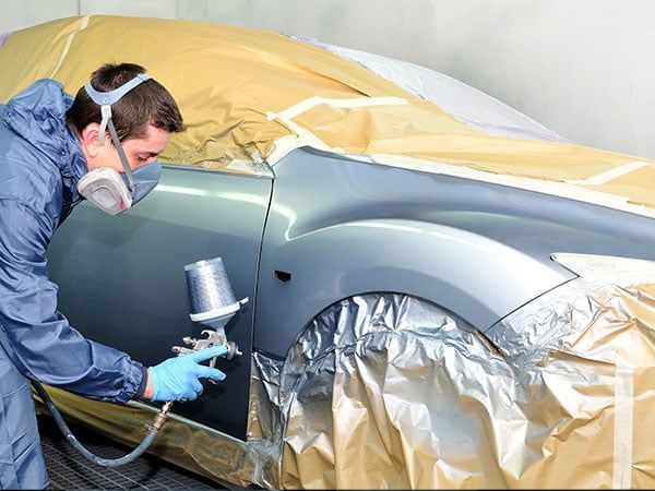 worker painting car