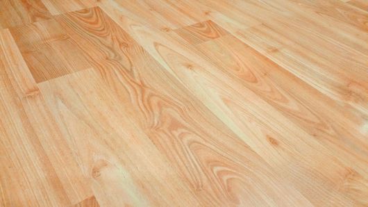Light wood laminate flooring with warm beige and tan grain patterns