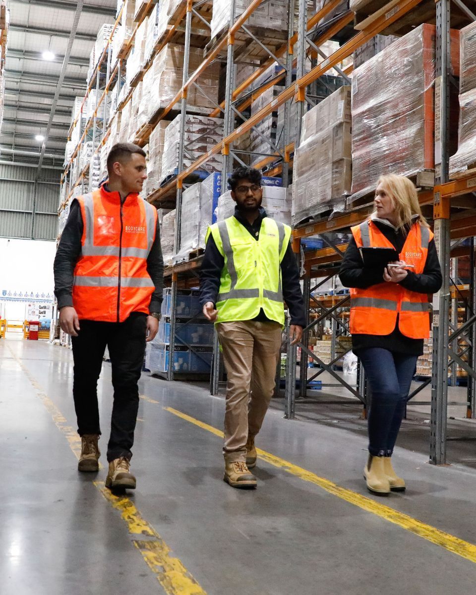 Bodycare NZ are walking through a warehouse.