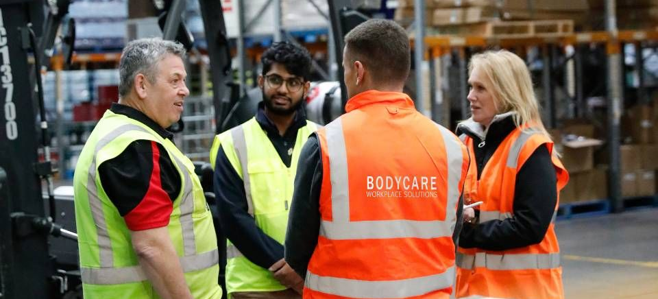 A man is sitting at a desk in front of a computer.