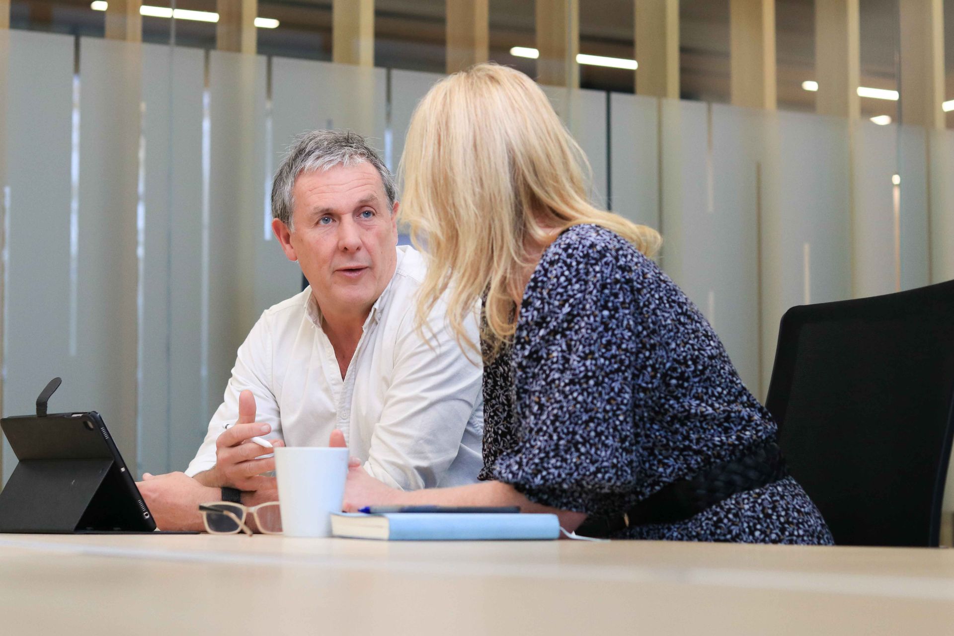 Bodycare NZ sitting at a table talking to each other.