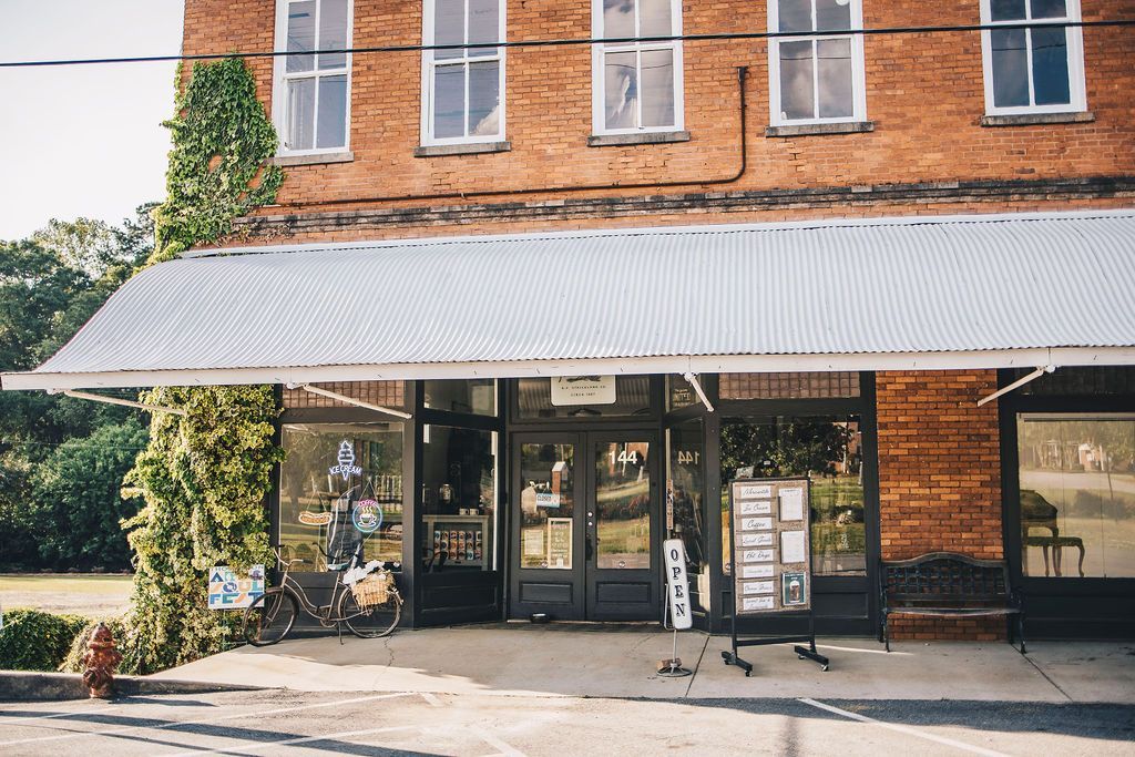 A brick building with a white awning on the front of it.