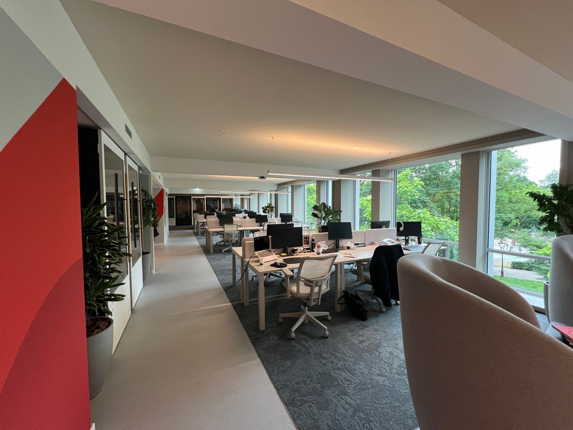 Una oficina grande con muchos escritorios y sillas.