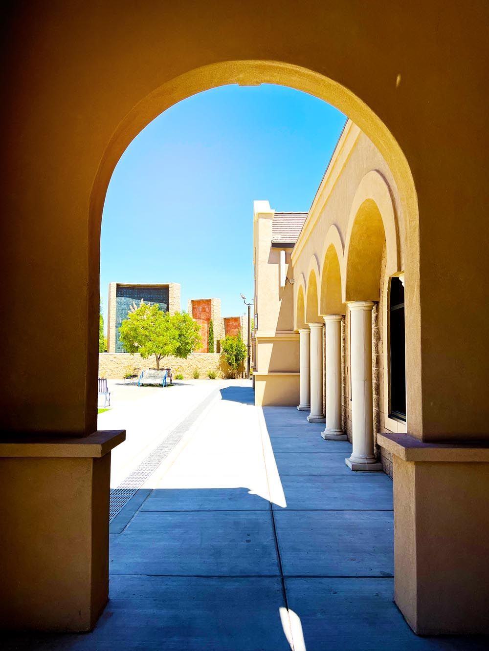 A view of a building through an archway on a sunny day