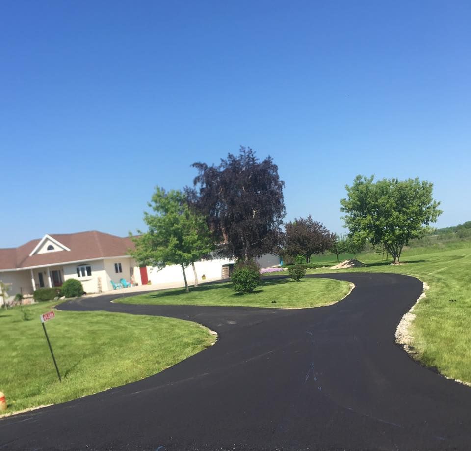 A driveway leading to a house on a sunny day
