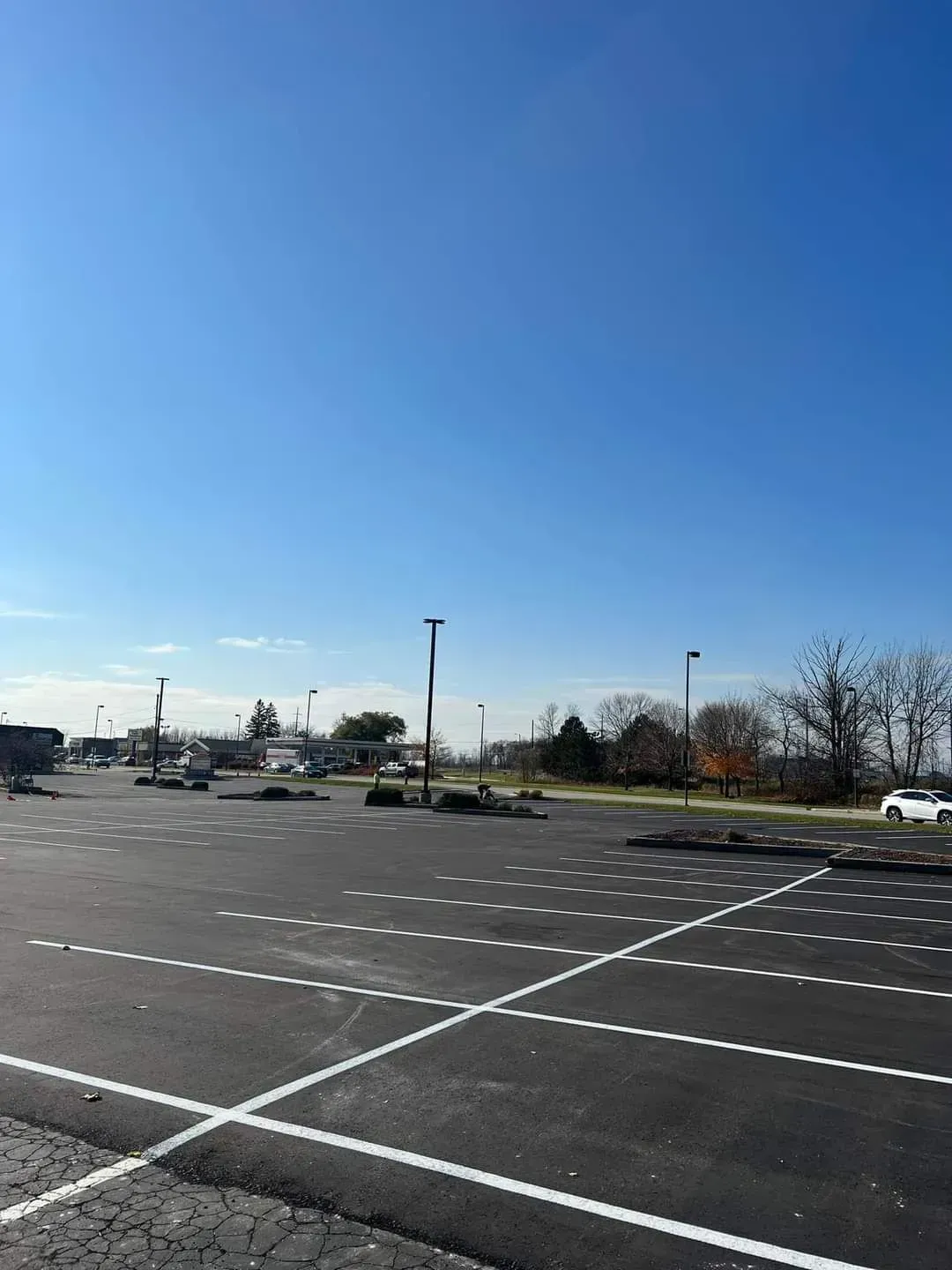 A parking lot with cars parked in it on a sunny day.