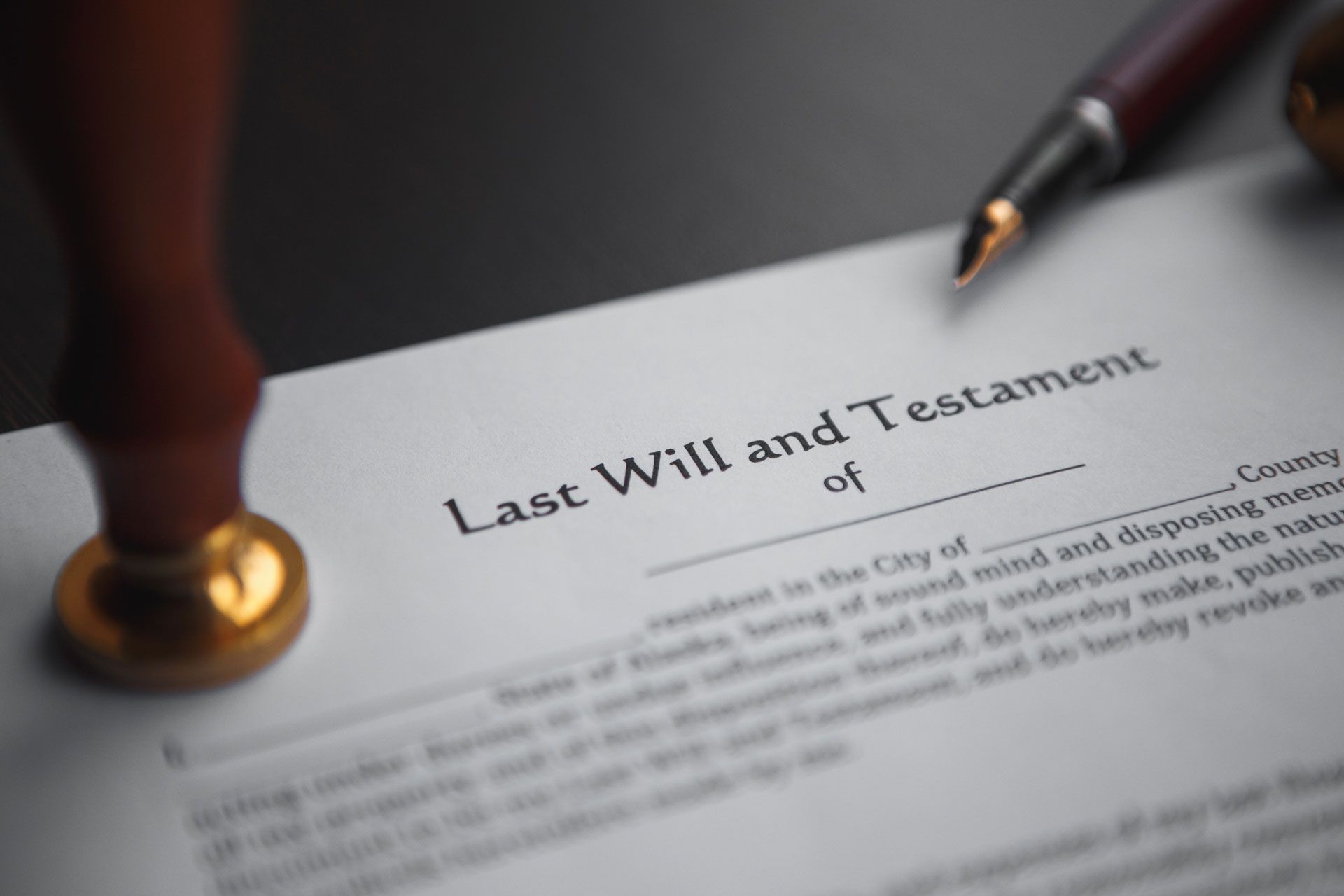 A pen is sitting on top of a last will and testament