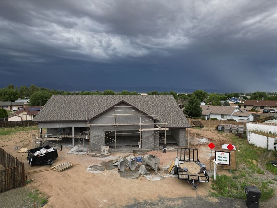 House under construction with stormy sky background.