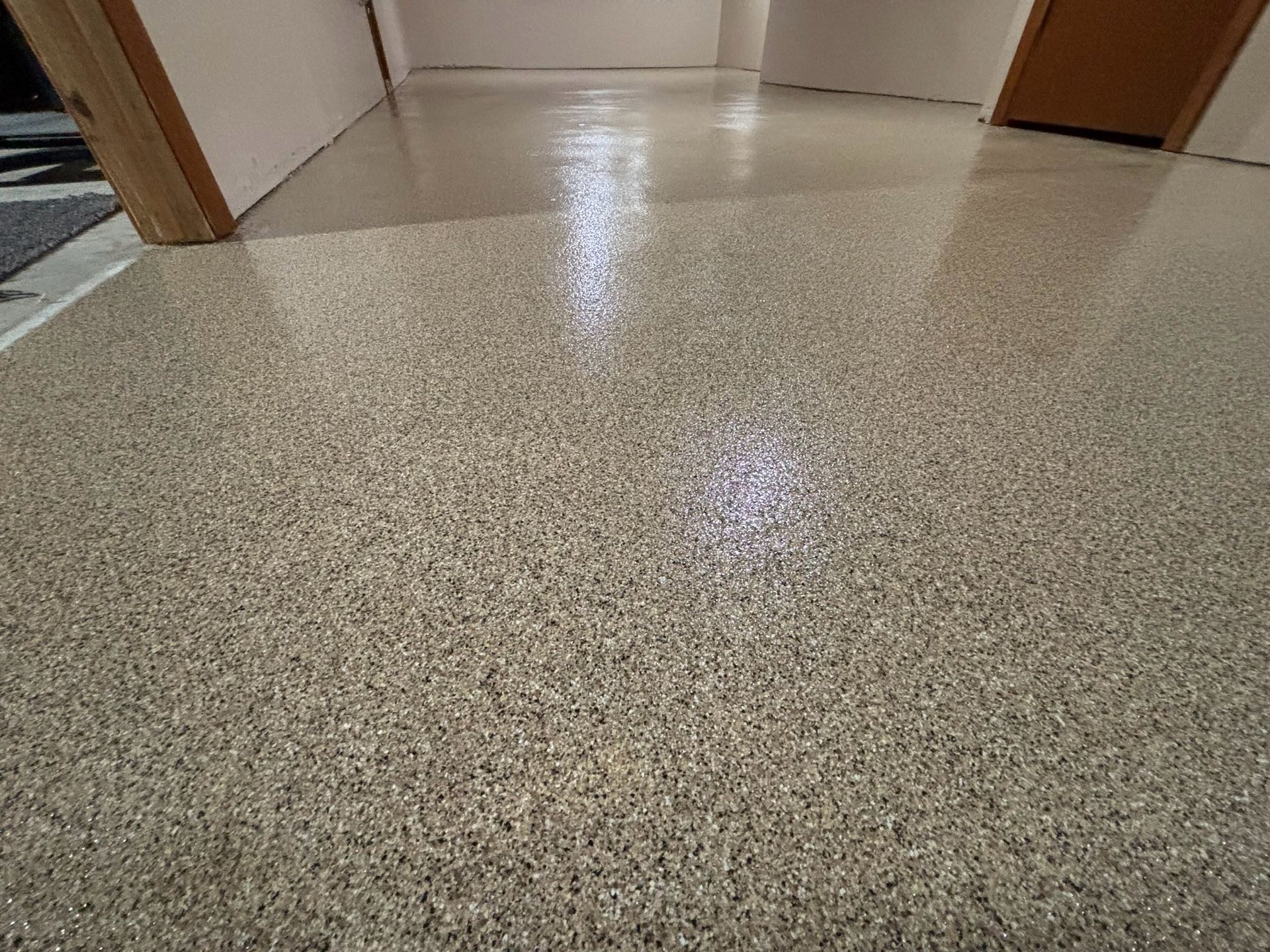 Shiny speckled epoxy flooring in a room.