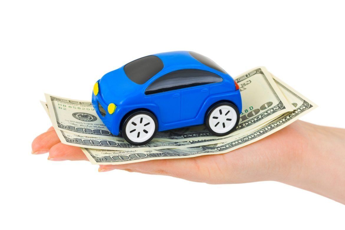 Toy Car And Money On Hands — Oklahoma City, OK — Freeman Collision Center