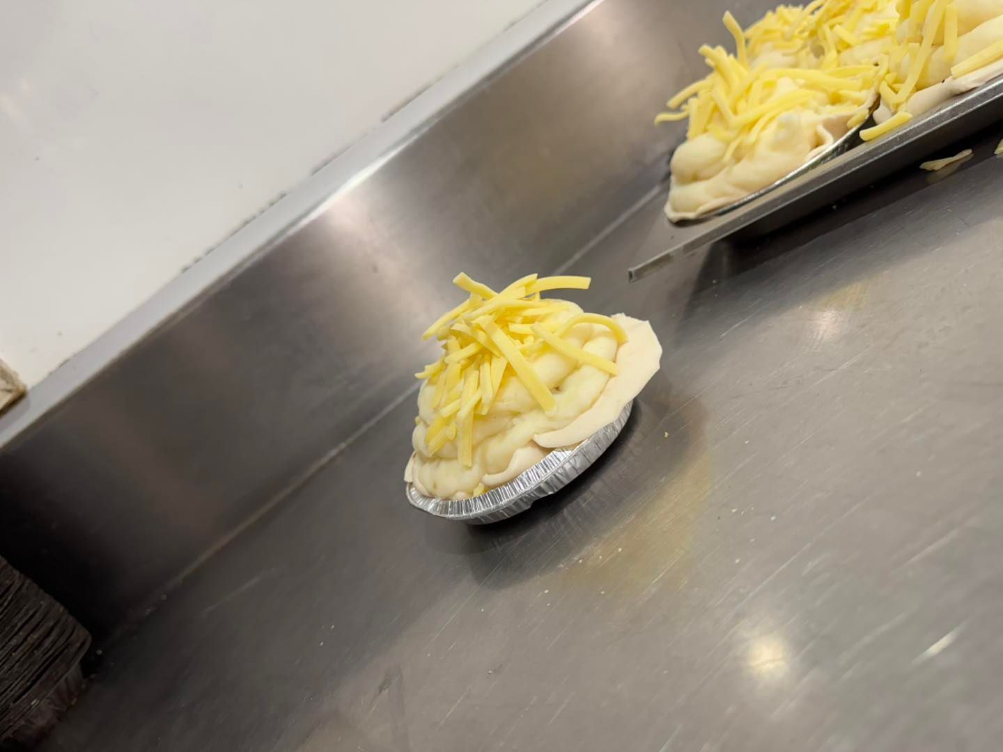 Two Macaroni and Cheese Pies Are Sitting on a Stainless Steel Counter — Lismore Pie Cart in Lismore, NSW