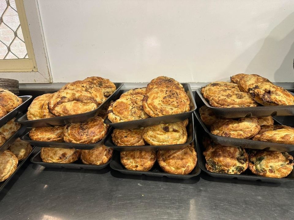 A Bunch of Pastries Are Stacked on Top of Each Other on a Counter — Lismore Pie Cart in Lismore, NSW