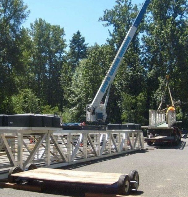 A crane loading a large piece of material — Oregon City, OR  — Bud's Crane Service Inc